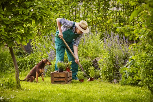 Gardener preparing tools at an accessible garden entrance in Archway
